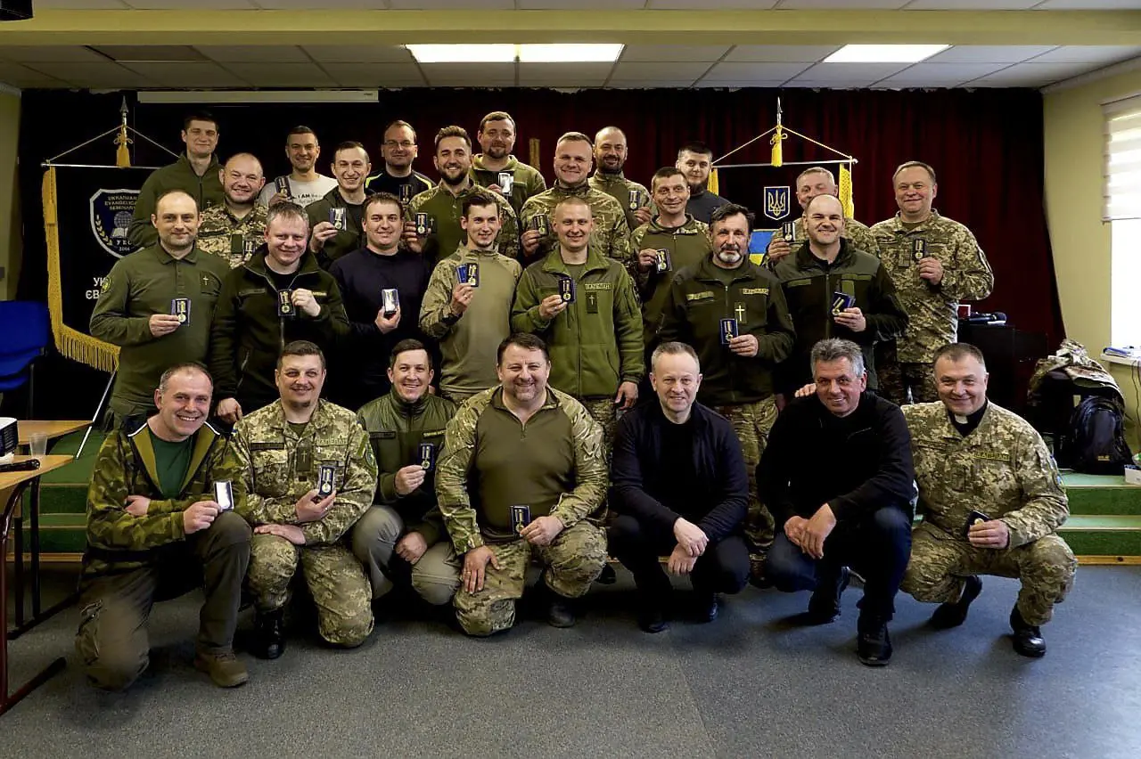 Group shot of Ukraine Chaplains dressed in military uniform, holding medals
