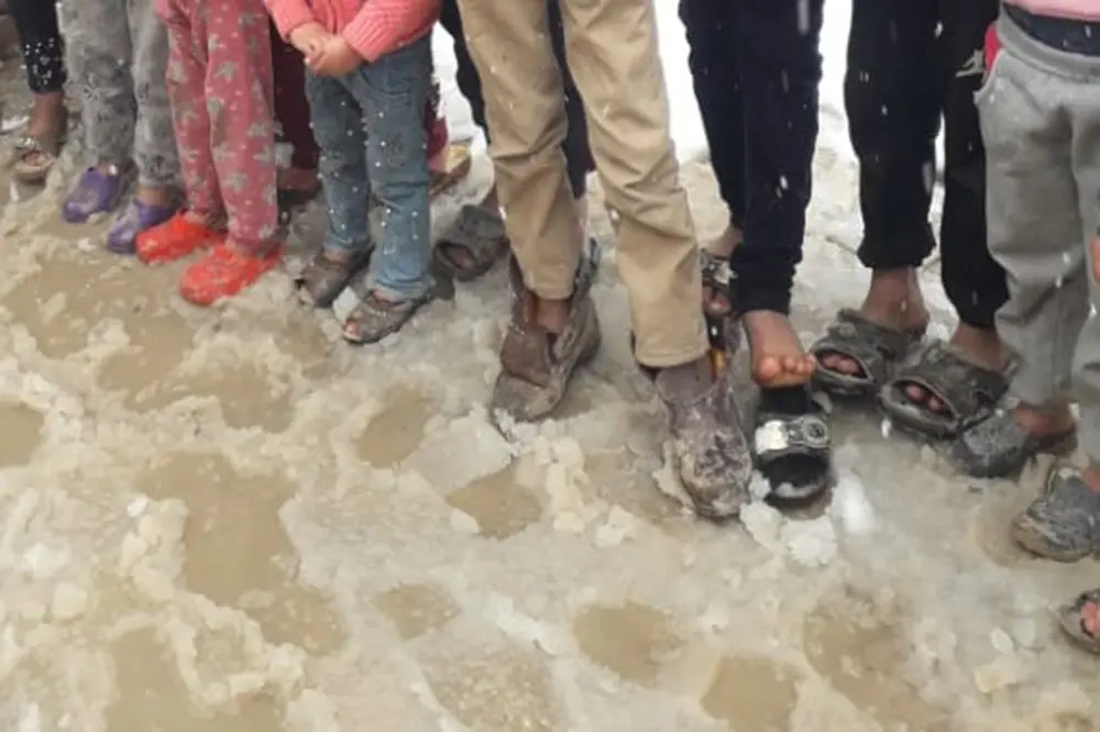 Syrian refugee Children with Feet In Snow